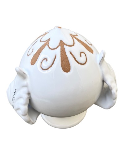 Pumo bianco Poz Studio inciso a goccia su tavolino in legno circondato da foglie d'ulivo pugliese